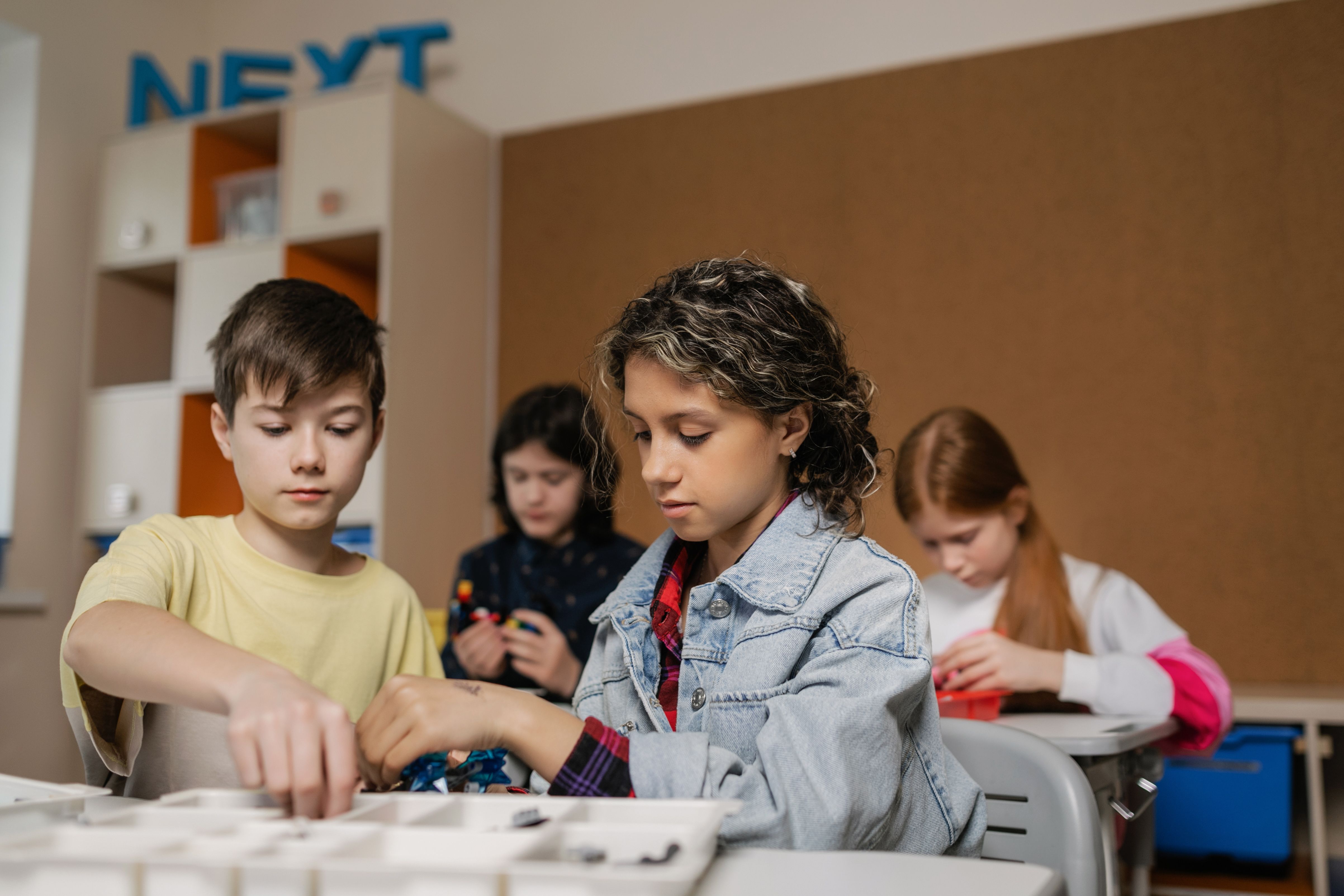 elementary aged students building with Lego